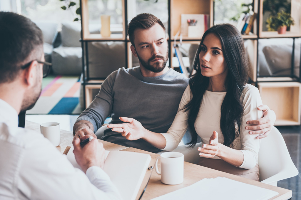 A couple talking through their questions with a consultant
